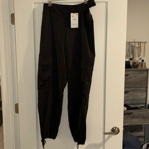 Women's brand new Zara silk jogger pants with side cut out in size M.